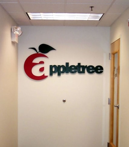 Three dimensional wall logo mounted to interior wall