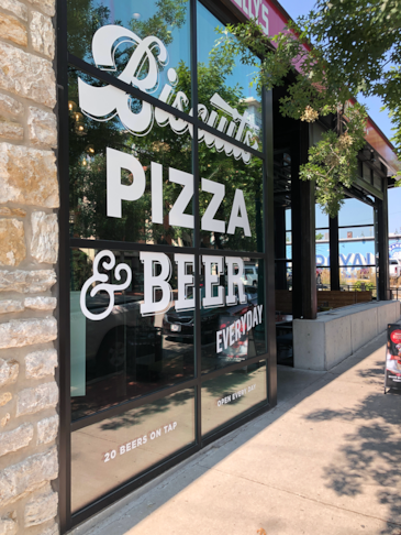 Cut White Vinyl Window Graphics for Atomic Provisions in Westport neighborhood of Kansas City, Missouri