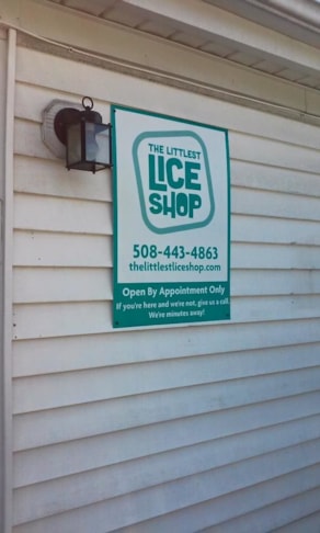 Sign on MDO with vinyl face mounted on exterior wall