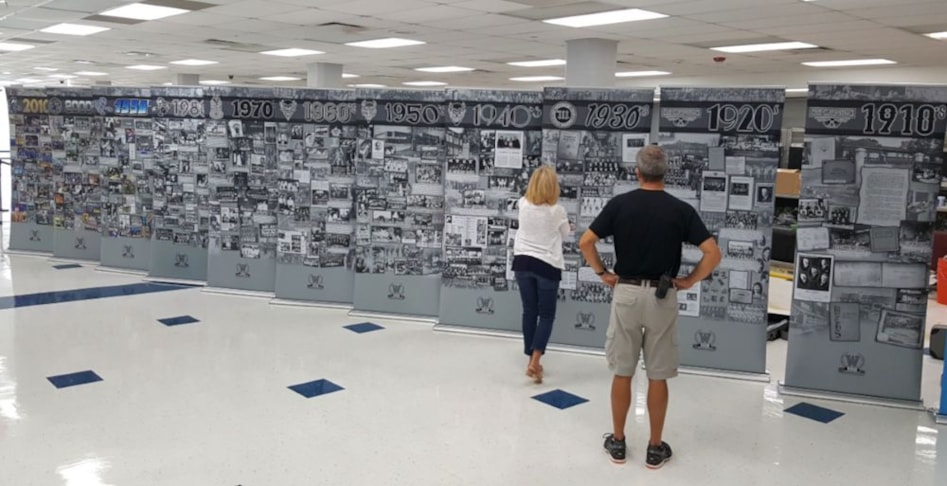 Signs Now / Image 360 of Gurnee is proud to have designed these panels for Warren High Schools 100th Anniversary. Each panel celebrates one decade using yearbook excerpts. Retractable banners stands were used for a traveling display used at many events.