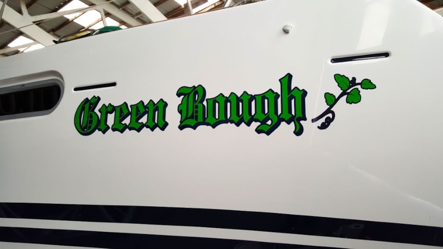 Boat name lettering and graphics in three colors applied to sailboat in Waukegan, IL