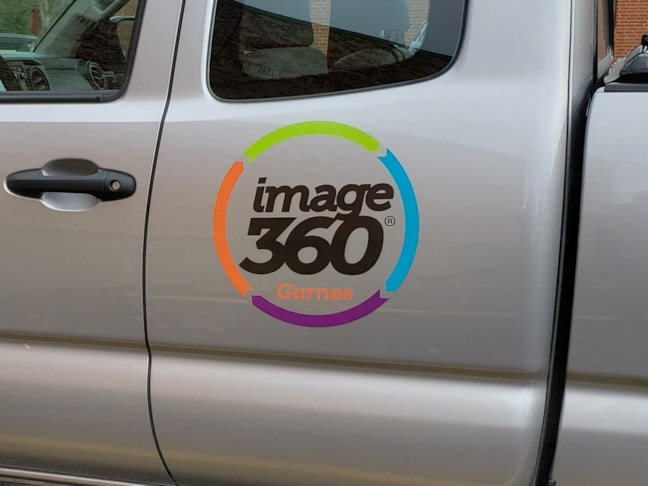 Reflective magnetic truck logo sign with the background matching the paint.  It does not look like one piece.  