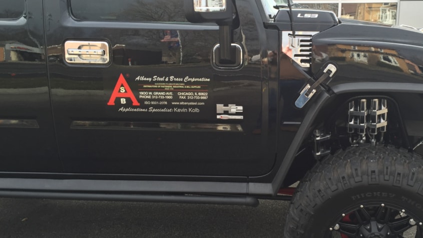 H2 with magnet sign. Red and chrome logo and lettering over black go nicely on the black Hummer SUV.