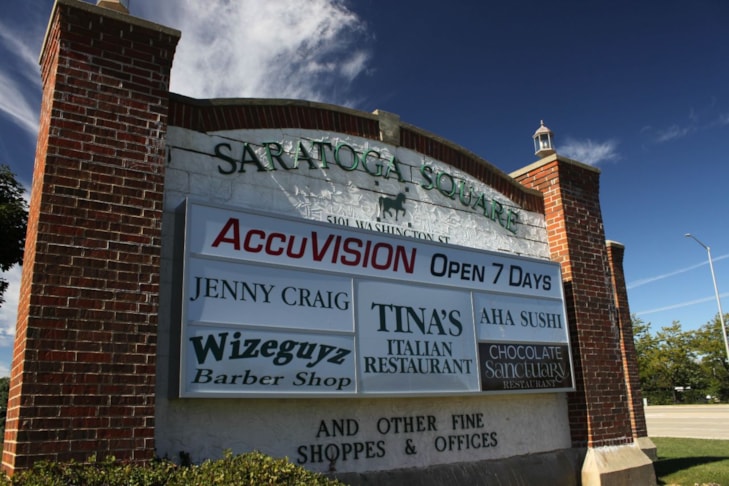 We upgraded this monument sign for Saratoga Square, in Gurnee IL by adding lighted boxes to each side. Each box has six individual changeable tenant panels.