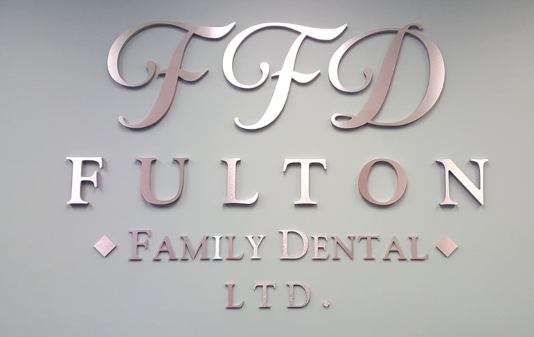 Brushed metal logo for reception desk area