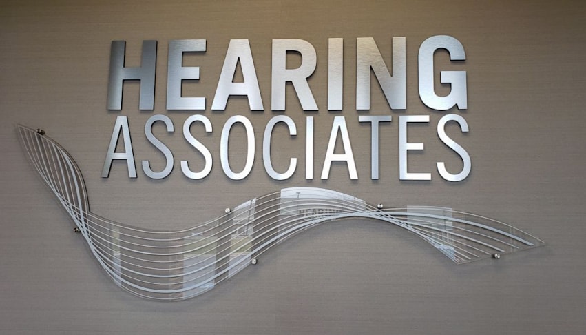 3D logo using brushed aluminum dimensional letters and acrylic wave on standoffs