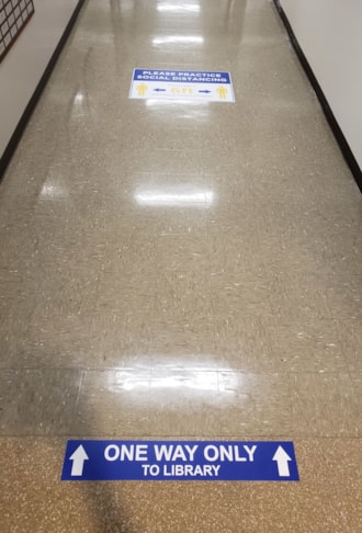 COVID 19: One way and 6 Social Distancing Decals on Tile Floor